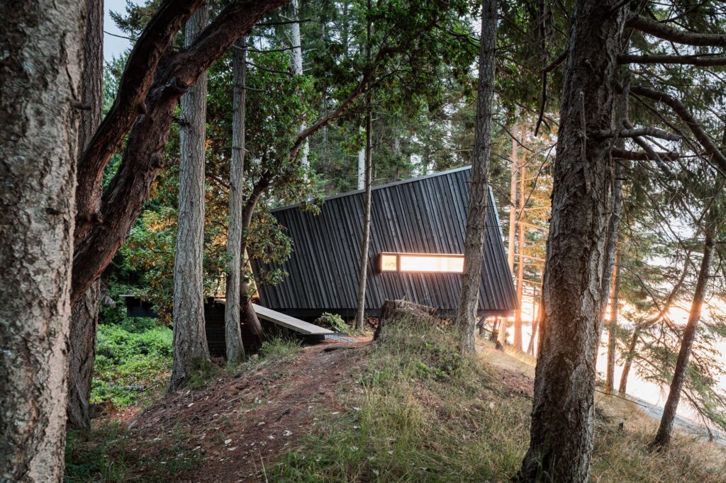 Dark wood cabin at sunset