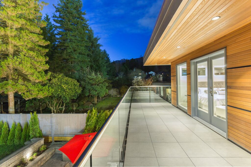 Wood cladding and soffit along a glass balcony