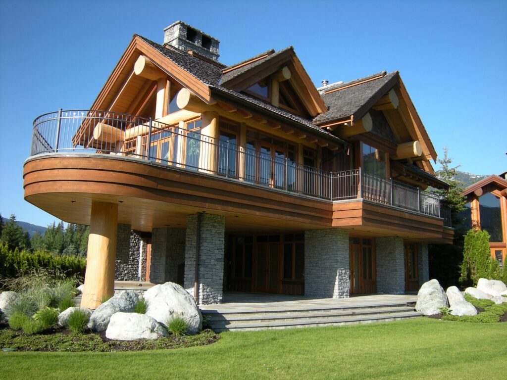 Timber home with a curved wood balcony and soffit