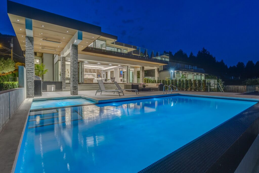 Wood soffits over a pool terrace at dusk