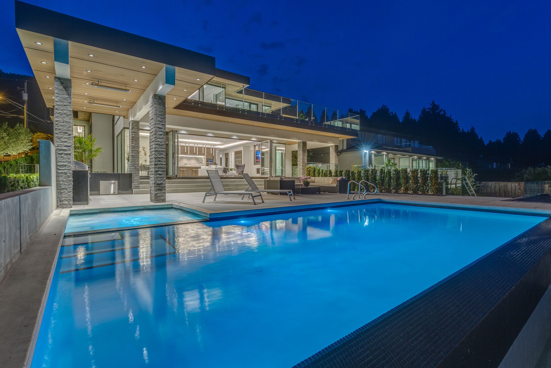 Wood soffits over a pool terrace at dusk