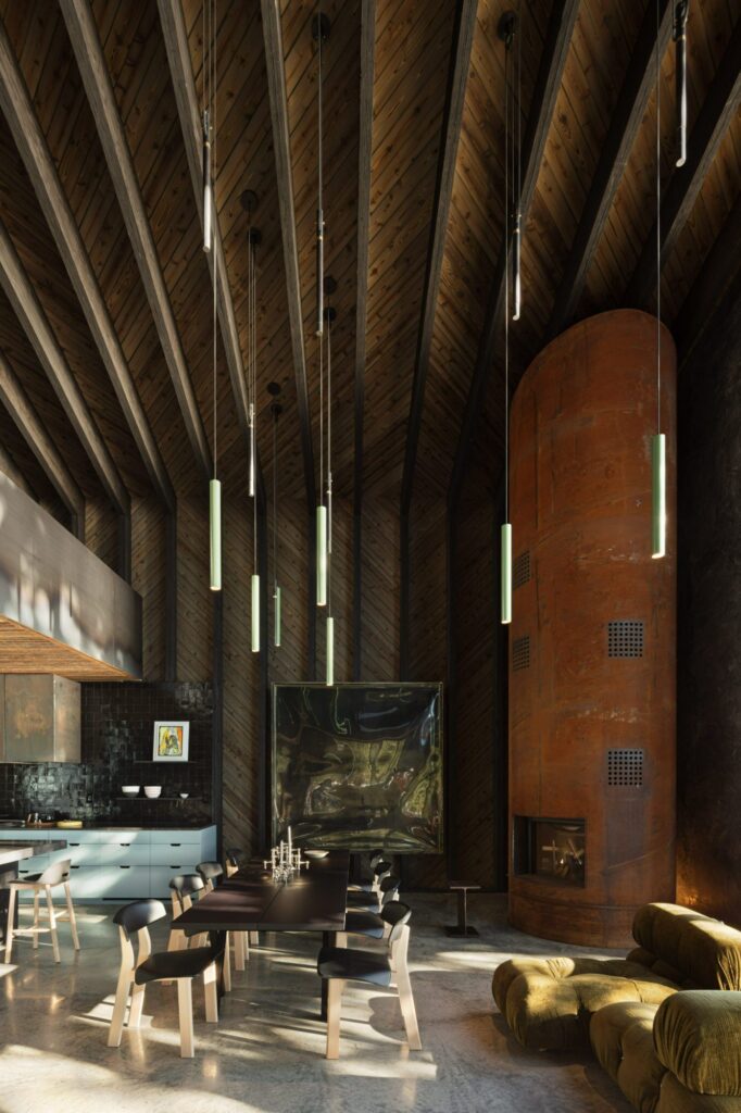 Dark wood ceiling and walls in a double-height dining room