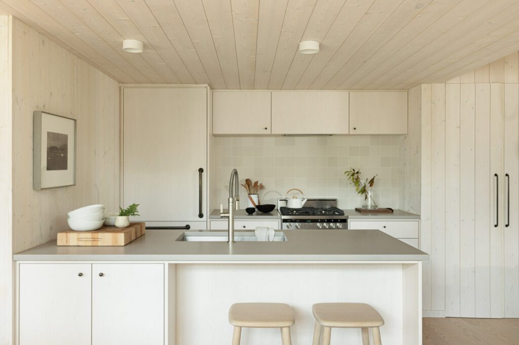 Light wood walls and ceiling in a white kitchen