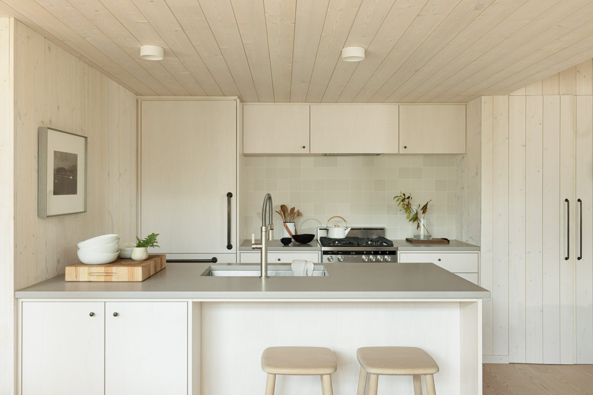 Light wood walls and ceiling in a white kitchen