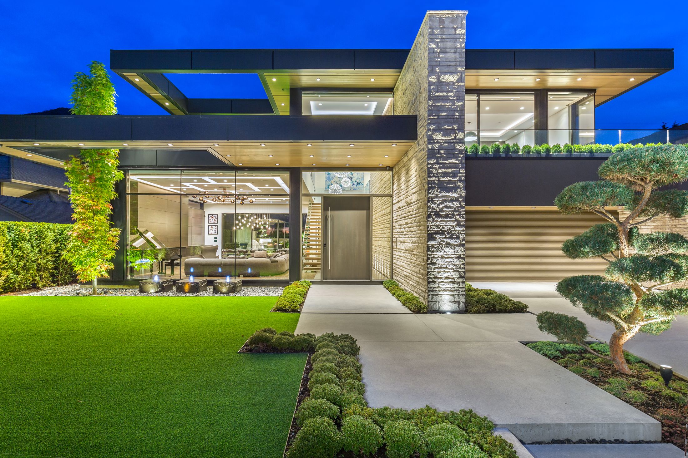 Modern home with wood soffits at dusk